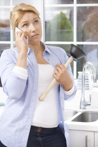 Frustrated Woman Calling Plumber To Fix Blocked Sink At Home